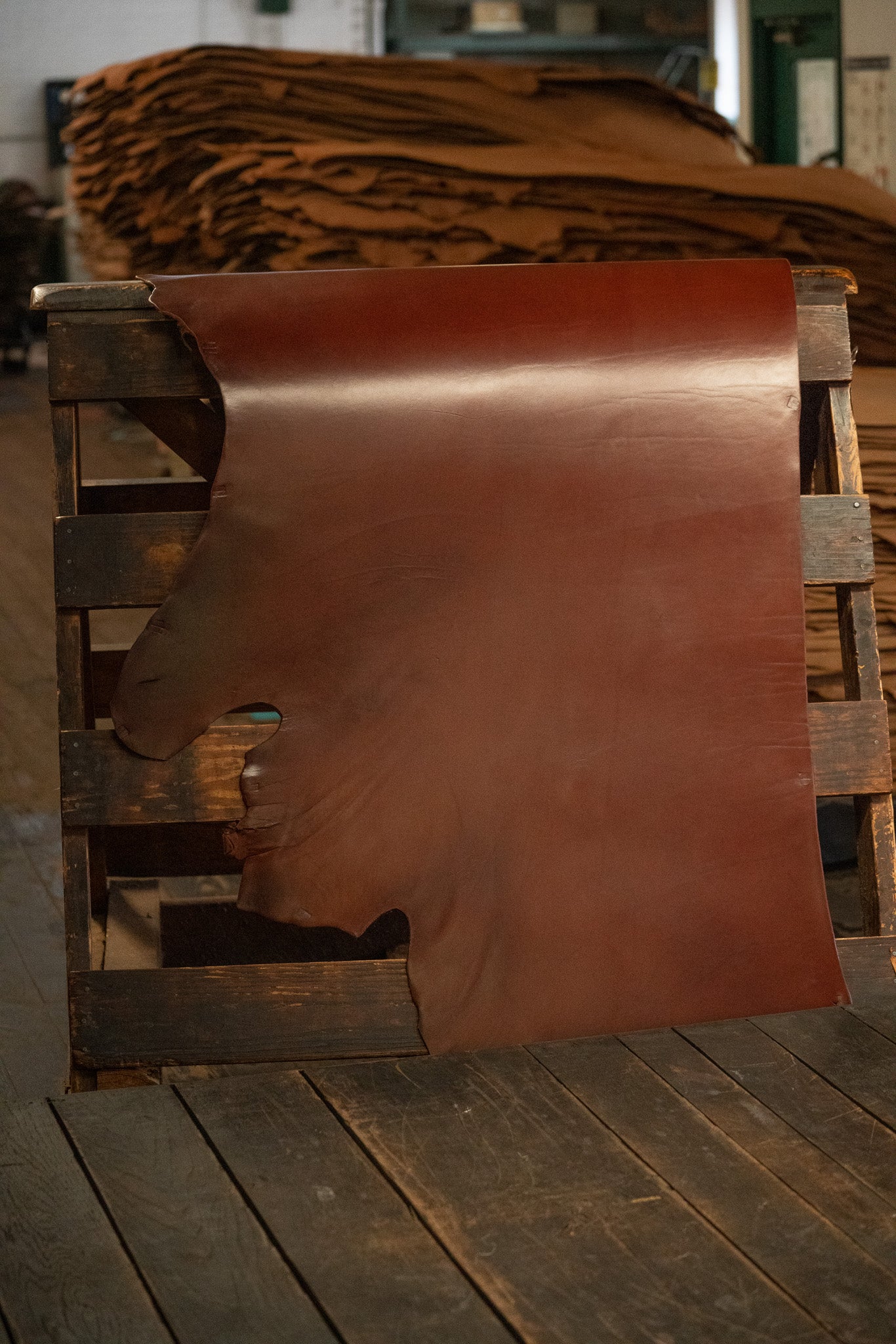 British Brown English Bridle Leather from Hermann Oak Leather Co displayed on a wooden rack
