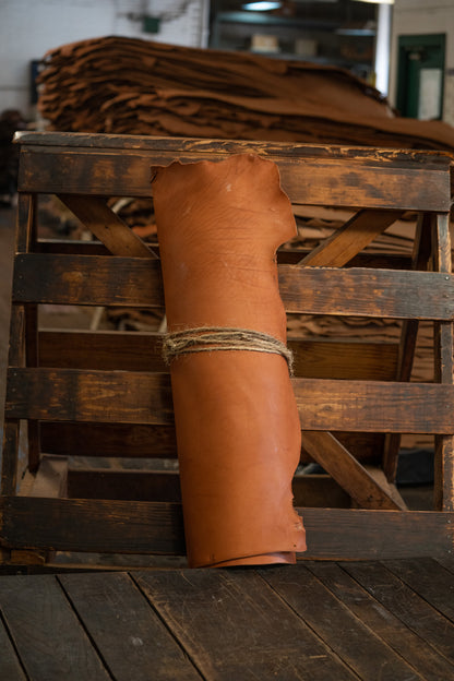 Chestnut Skirting Leather from Hermann Oak Leather Co rolled and tied with twine